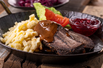 closeup of a german sauerbraten with dumplings