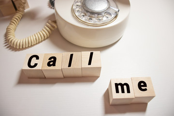 red handset and text Call me on black desk