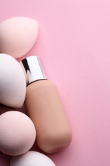 Conatainer with fluid foundation with beauty blender.Cosmetic branding, glamour and skincare...