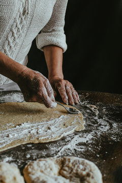 A Woman Prepares Homemade Braided Bread at Home