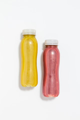 Use less plastic! Smoothie in plastic packaging isolated on white ground. Symbol for environmental pollution done by the food industry