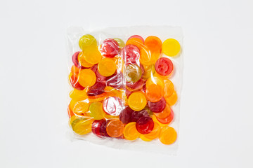 Use less plastic! wine gums in plastic packaging isolated on white ground. Symbol for environmental pollution done by the food industry