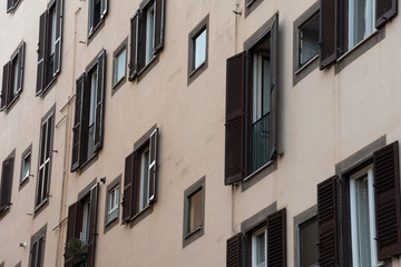 Fototapeta na wymiar Wall with multiple windows and shutters. 