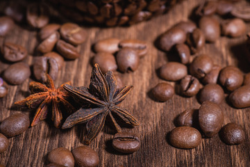 Background for coffee beans in dark colors for the background. Coffee Coffee Beans Cinnamon Stick Anise Star Wooden Table Close-up.