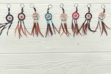 Ethnic dreamcatchers on a wooden background. Dream catchers, indian amulet, feathers, decoration.