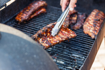chef cooks ribs at the street food festival