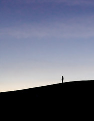 silhouette of man on top of mountain