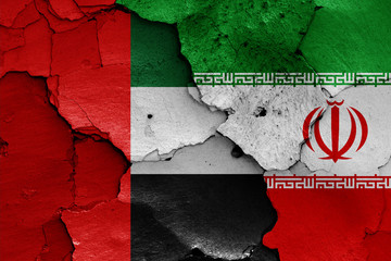 flags of UAE and Iran painted on cracked wall