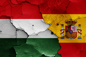 flags of Hungary and Spain painted on cracked wall