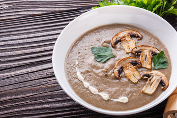 mushroom cream soup on rustic wooden background