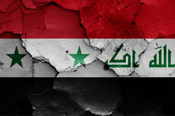 flags of Syria and Iraq painted on cracked wall