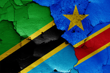 flags of Tanzania and DR Congo painted on cracked wall