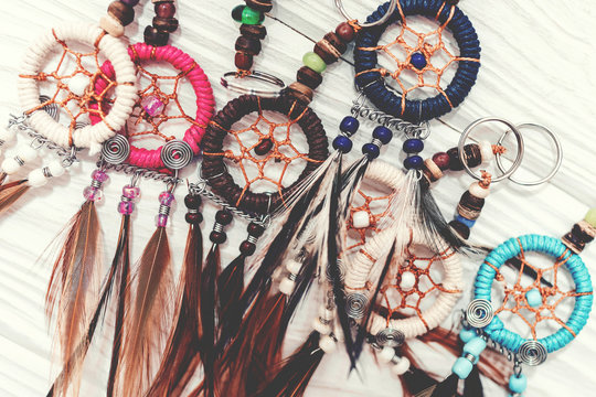 Ethnic dreamcatchers on a wooden background. Dream catchers, indian amulet, feathers, decoration.
