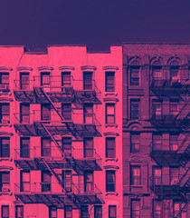 Fire escapes on the exterior of old buildings in New York City in pink and blue color