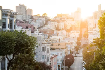 Fotobehang Street scene in downtown San Francisco California with the warm light of sunset shining © deberarr