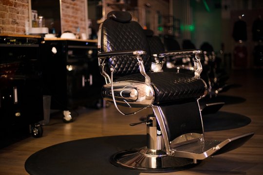 Black Leather Barber Chair With A Blurred Background