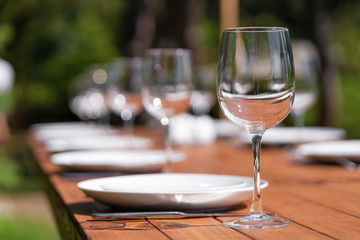 Served wooden table without a tablecloth. Cafe in the open air park
