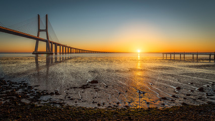 Fototapeta na wymiar Vasco de Gama bridge at sunrise with sunrise