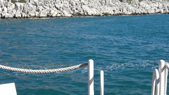 Andrea Doria Bay, Finike, Turkey - 10th of January 2020: 4K Zoom out beautiful bay view and a secluded swim platform with a chair