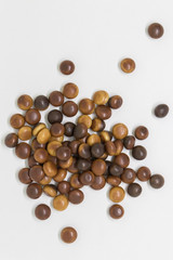 Confectionery milk chocolate in dragee on a white background
