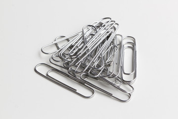 Recycled paper clips isolated on white.