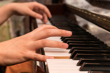 Obraz premium Hands of a girl playing the piano close-up