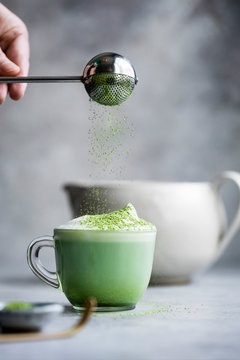 Matcha latte drink on a gray bakground