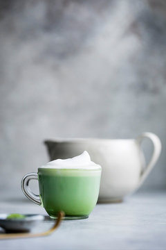 Matcha latte drink on a gray bakground