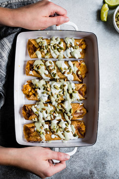 Cheesy pumpkin taquitos with roasted jalapeno pepita crema