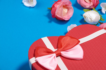The Background Of Valentine's Day. Gifts, flowers, heart, box in pastel blue colors. The Concept Of Valentine's Day. Flat sunbed, top view, copy space