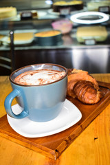 
breakfast with butter bread and hot cappuccino