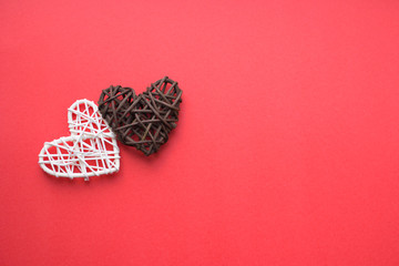 White and brown wooden heart on a red background. Love and Valentine's day concept