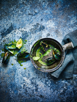 Emply bowl of mussels in a bowl against a blue background