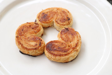 three palmier pastries on white plate