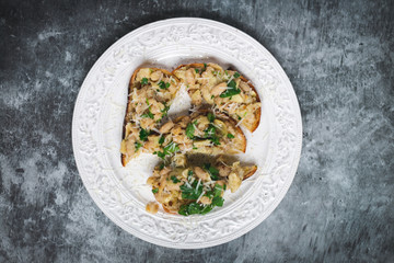 Toast slices with white lemon beans on top, styled dark background