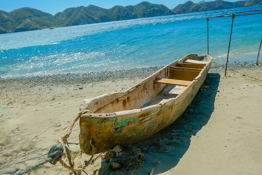 wooden boat abandoned on the beach