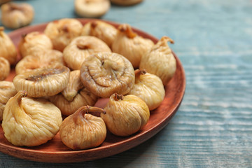 Tasty dried figs on light blue wooden table, closeup