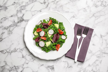 Delicious kale salad on marble table, flat lay