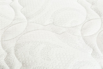Modern comfortable orthopedic mattress as background, closeup