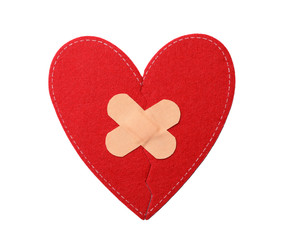 Fototapeta premium Red fabric heart with sticking plasters isolated on white, top view