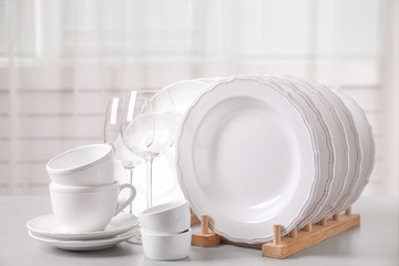 Set of clean tableware on light grey table