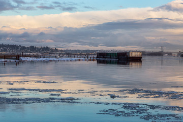 Beautiful View of Fraser River in the City during a cold and icy winter sunset. Taken in New Westminster, Vancouver, British Columbia, Canada.