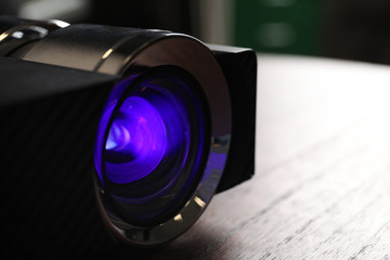 Fototapeta na wymiar Closeup view of modern digital video projector on table