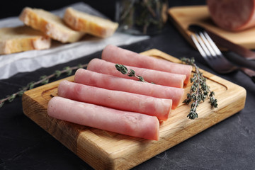 Slices of tasty ham on black table, closeup