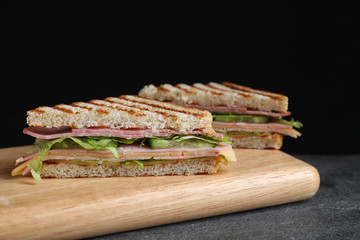 Tasty sandwich with ham on grey table