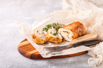 Chicken roll and vegetables on a table. Selective focus. Copy space