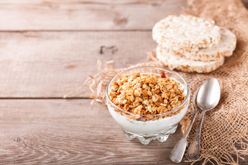 Muesli and yogurt in a glass on a table. Selective focus. Copy space for text