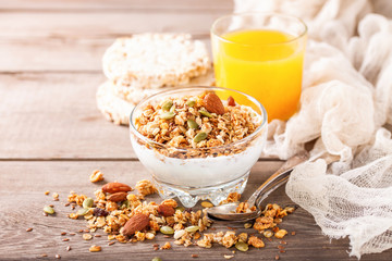 Muesli and yogurt in a glass on a table. Selective focus. Copy space for text