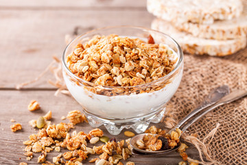 Muesli and yogurt in a glass on a table. Selective focus. Copy space for text