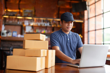 SME freelance man working with packaging startup entrepreneur small business owner at home,startup small business owner working with computer,Online business seller packaging and delivery concept.